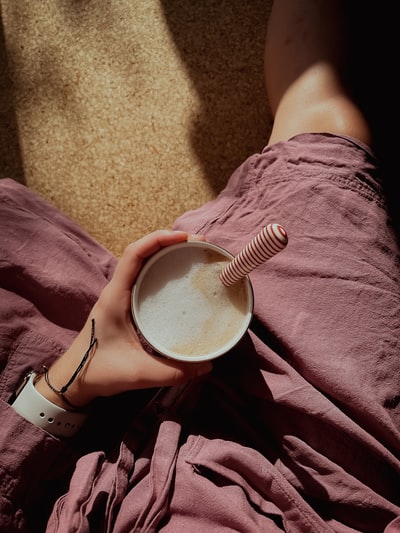 person holding white ceramic mug